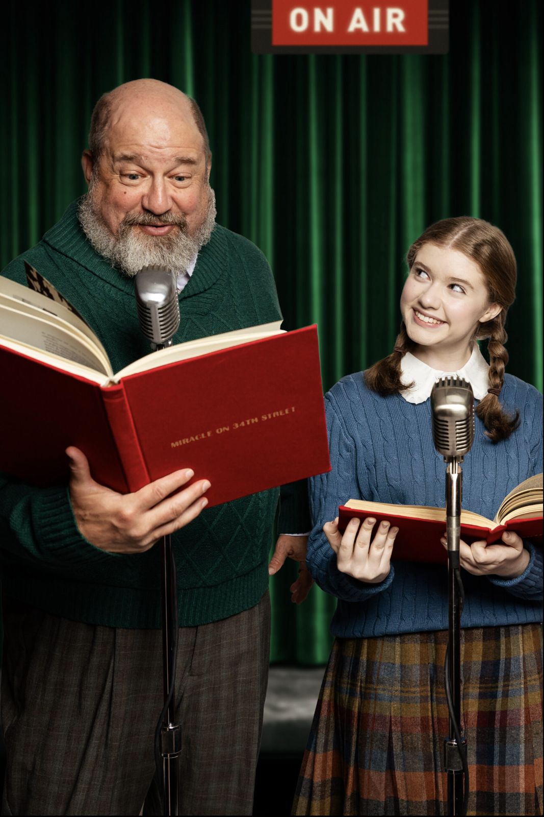 Parker Pitt as Gracie DeMarco at a radio microphone with Kris Kringle in Miracle on 34th Street: A Live Musical Radio Show at The Phoenix Theatre Company