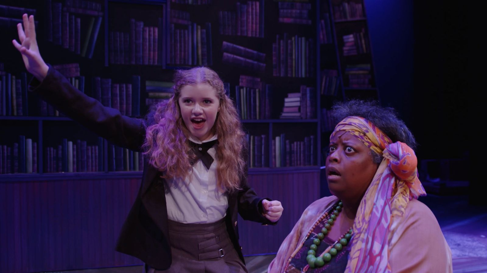 Parker Pitt as Matilda telling a story to Mrs Phelps the librarian in Matilda the Musical at TheaterWorks