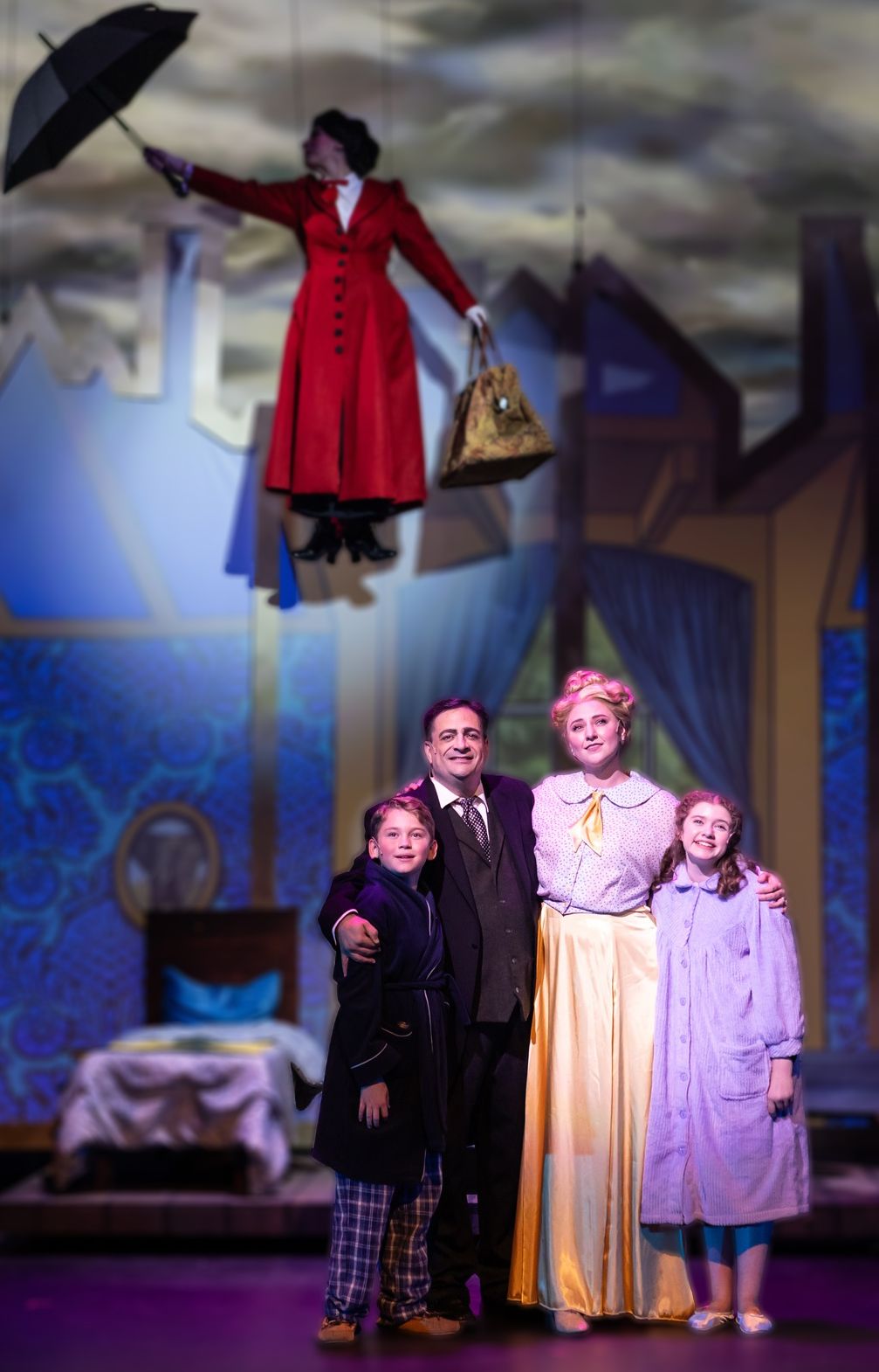 Parker Pitt as Jane Banks with the Banks family as Mary Poppins flies overhead in Mary Poppins at TheaterWorks