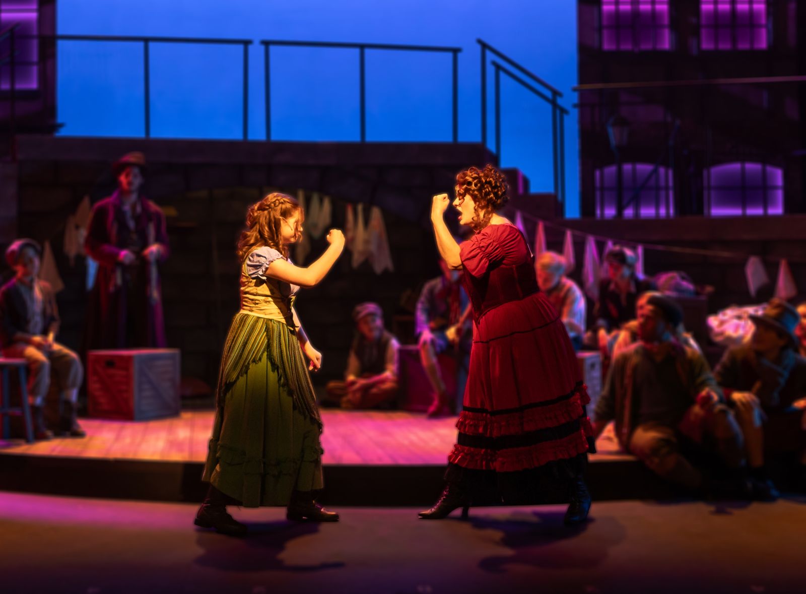 Parker Pitt as Bet dancing in a street scene in Oliver! at TheaterWorks