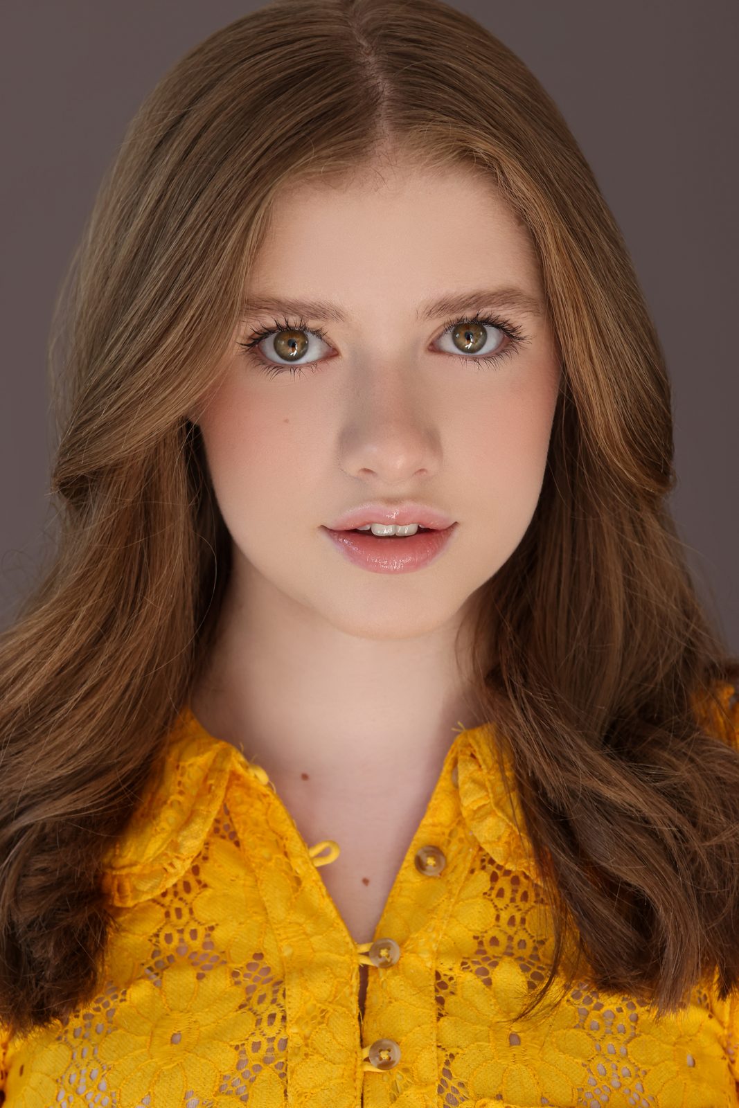 Parker Pitt, actor, 2025 headshot in a yellow lace blouse by Lilly K Photography