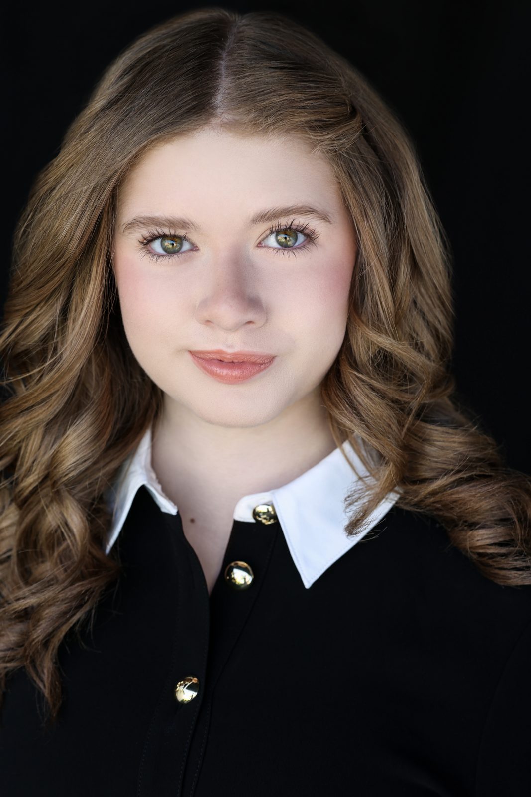Parker Pitt, actor, 2026 headshot in a black top with a white collar by Lilly K Photography