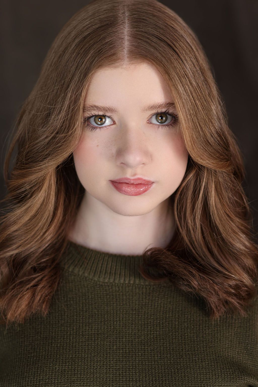 Parker Pitt, actor, headshot in a dark green sweater by Lilly K Photography