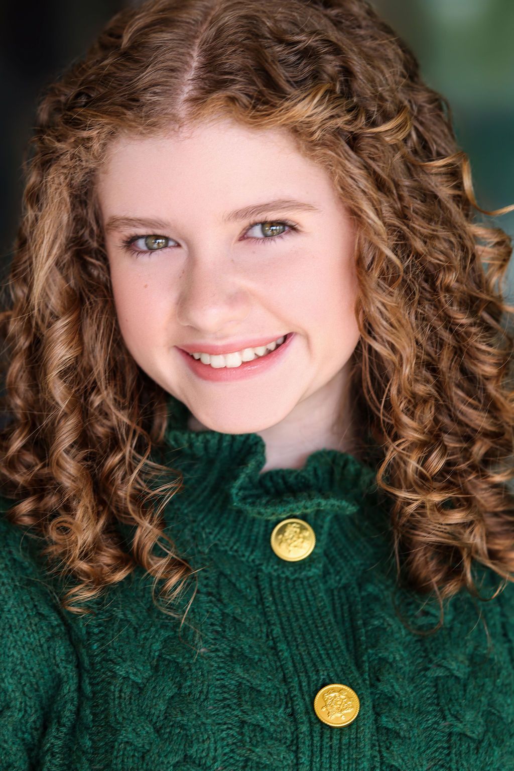Parker Pitt, actor, smiling headshot in a green cardigan by Lilly K Photography