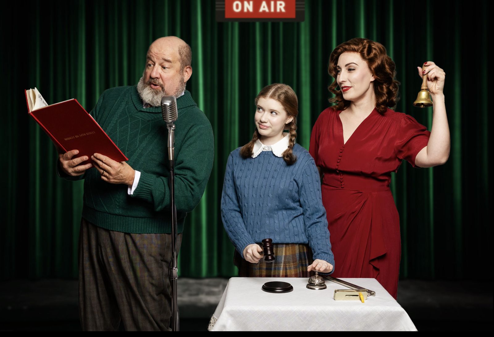 Parker Pitt as Gracie DeMarco reading a radio script with Kris Kringle and Doris Walker in Miracle on 34th Street: A Live Musical Radio Show at The Phoenix Theatre Company
