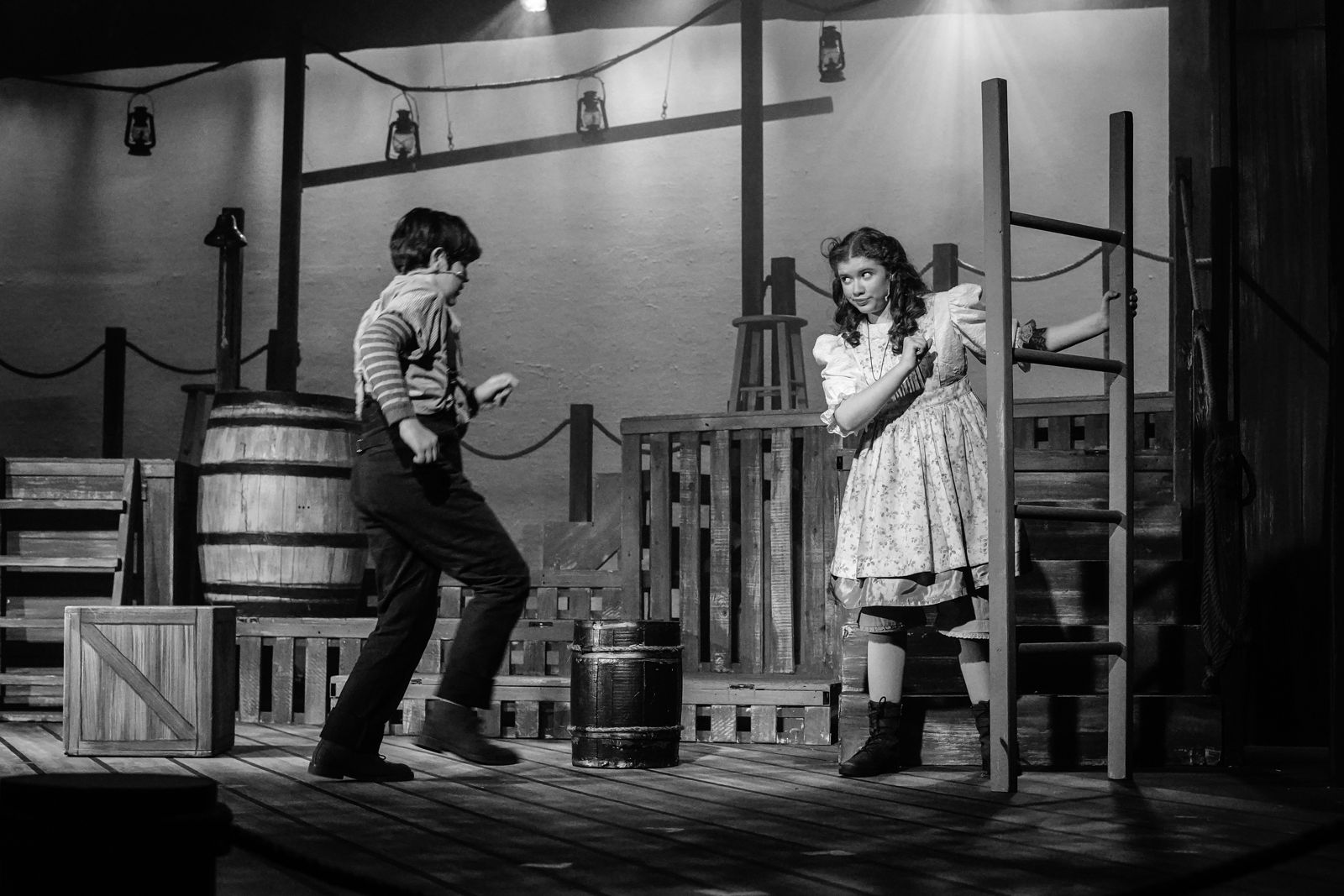 Parker Pitt as Molly Aster urging Peter to follow her in Peter and the Starcatcher at Valley Youth Theatre, black and white