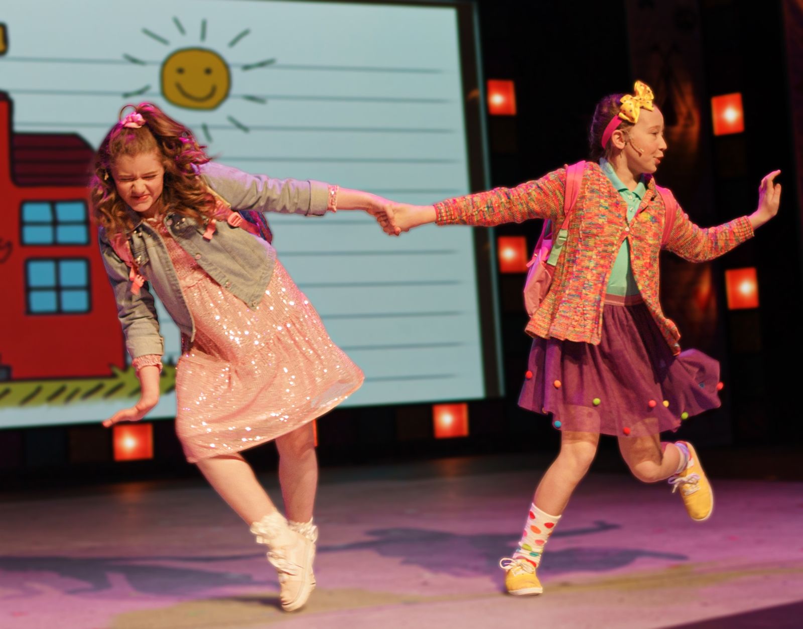 Parker Pitt as Lucille being pulled along by Junie B. in Junie B. Jones the Musical at Valley Youth Theatre