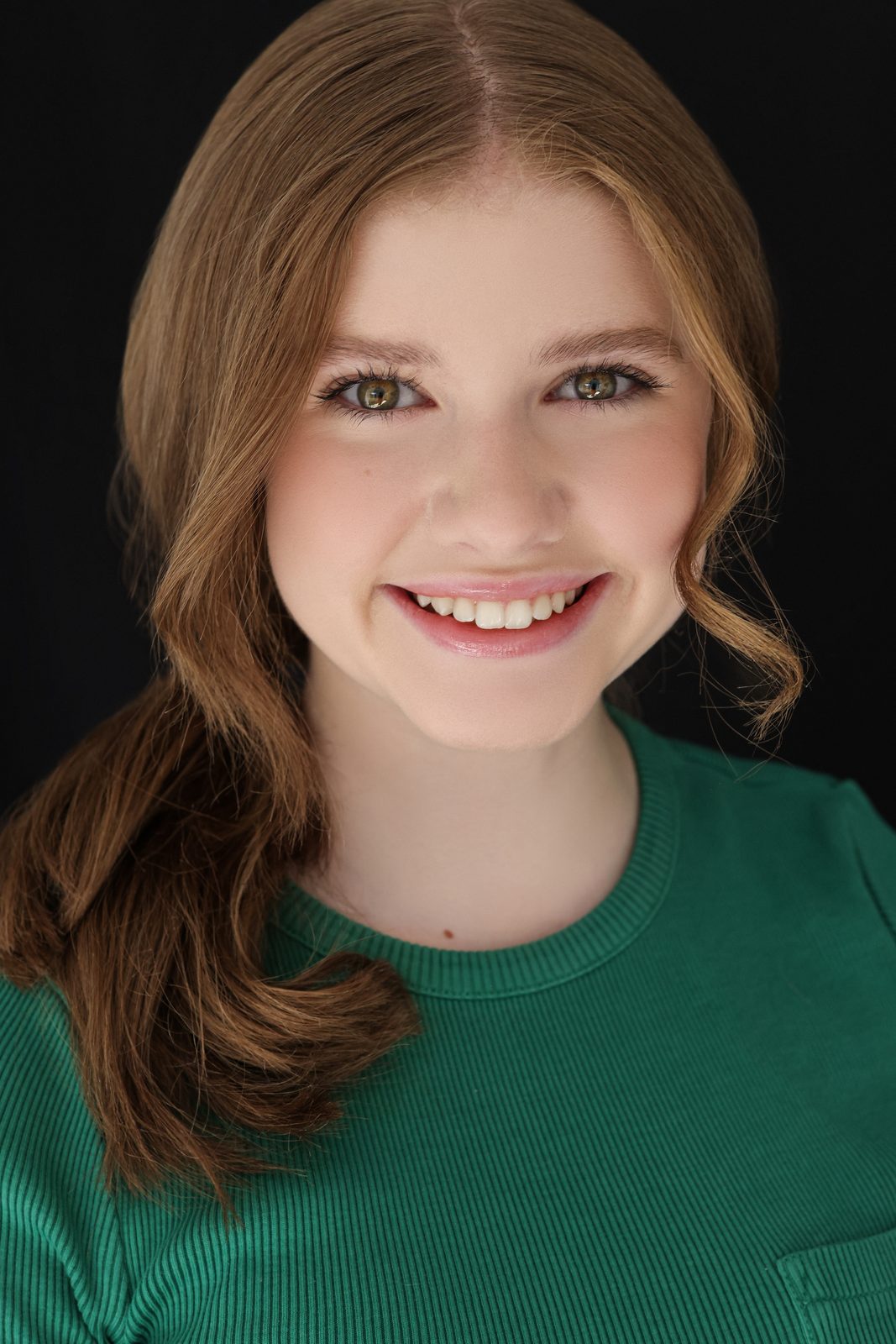 Parker Pitt, actor, smiling 2025 headshot in a green top by Lilly K Photography